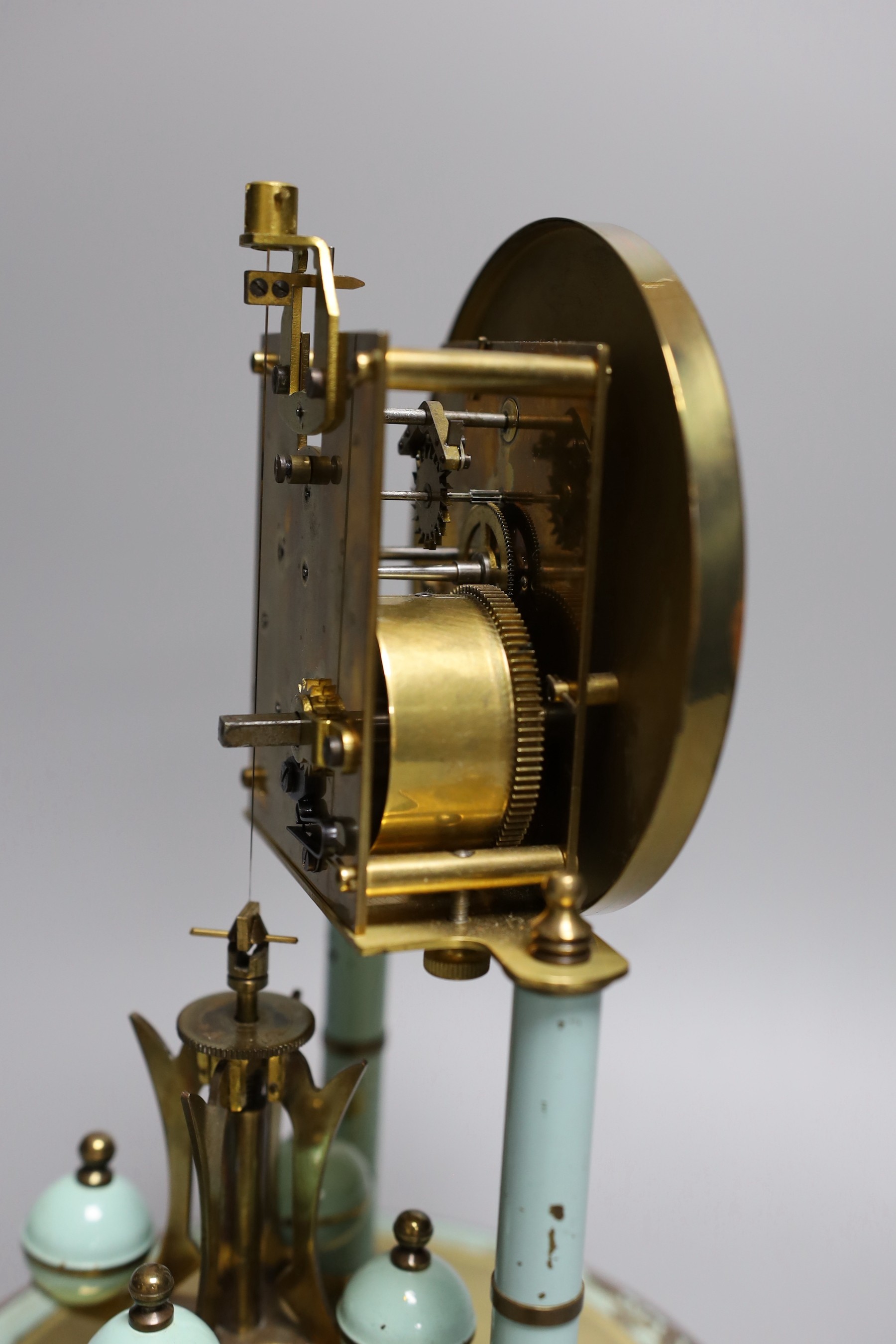 A German 400 day enamelled brass mantel timepiece, under a glass dome, 30cm total